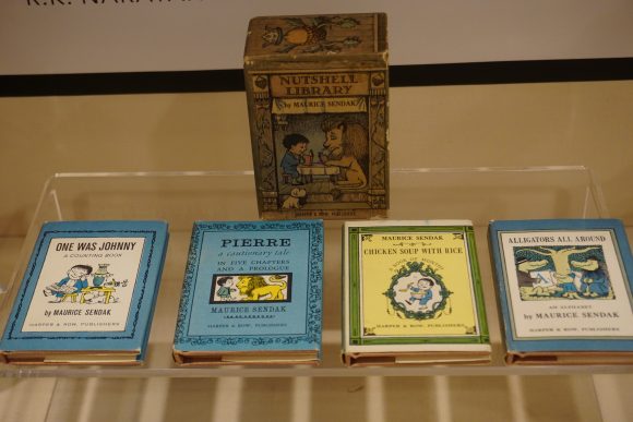 The "Nutshell Library," a small cardboard case, with four miniature books pulled out of in and laid in front - "One Was Johnny," "Chicken Soup and Rice," "Pierre," and "Alligators All Around.":