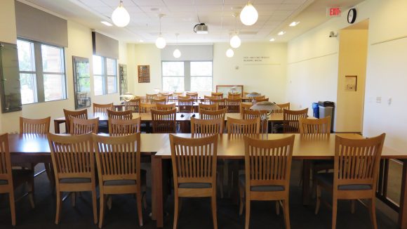 Image of the tables and chairs in the Doy and Dee Henley Reading Room, with no people.