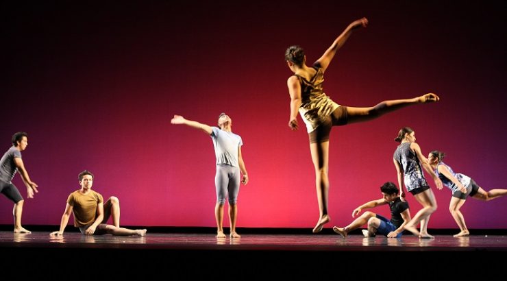 Students perform a dance performance on stage.