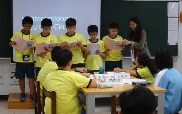 Wong guides five Taiwanese students reading in front of the class