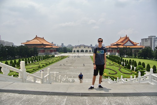 Ryan standing in front of open area outside of a Temple in Taiwan during his travel course.
