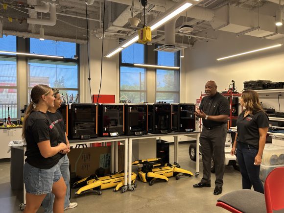 Dean Harris and students talking in the Tech Shop